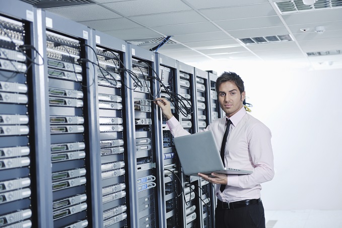 businessman with laptop in network server room Raffreddamento urgente di una sala server
